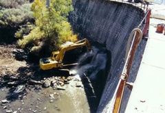 Backhoe Holding Plug in Dam- 1999  Restoration